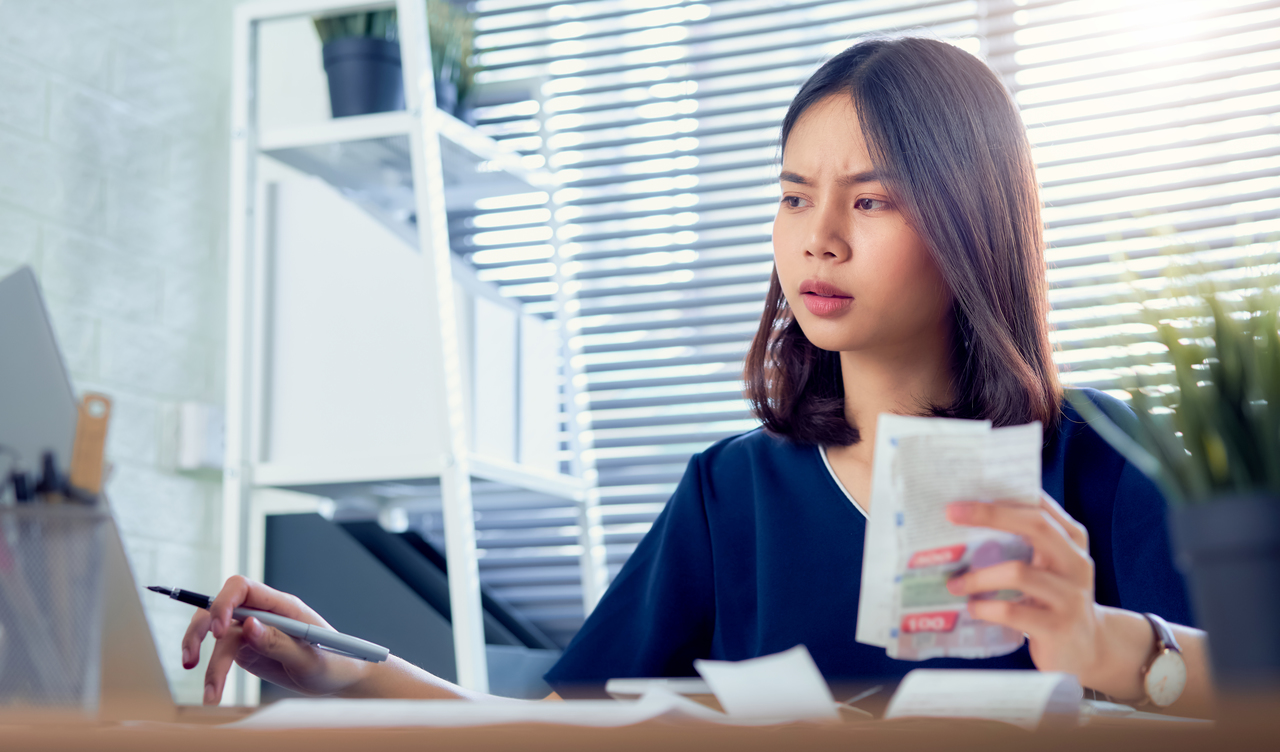 A young Asian woman doing her monthly electricity bills