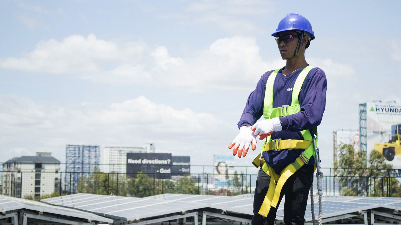 Solar energy worker installing grid panels