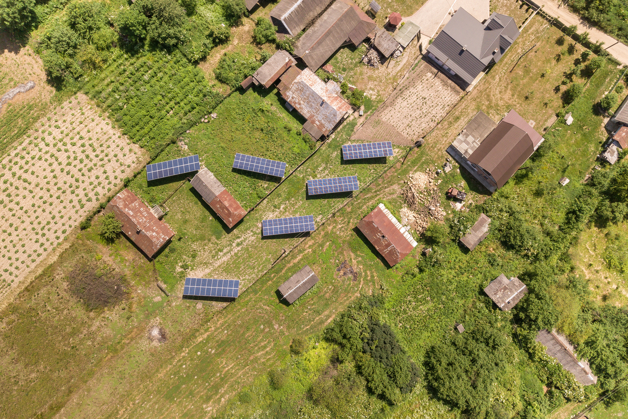 Extreme top shot of houses in a rural area with solar panels