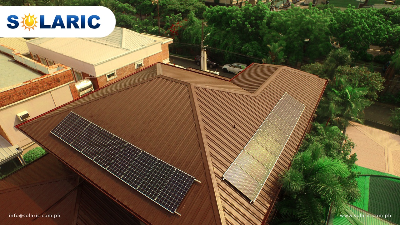 Top shot of solar panels on opposing sides of a brown roof