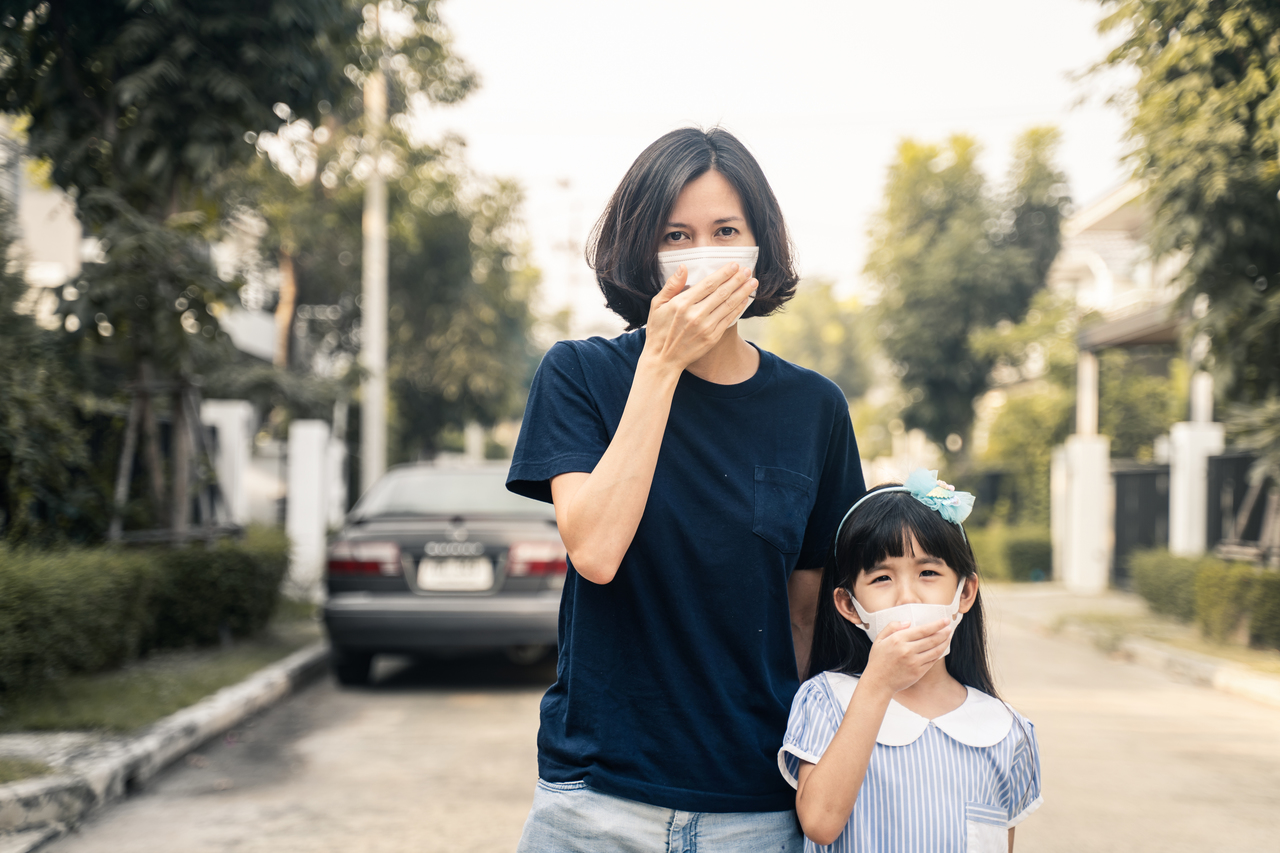A woman and her daughter wearing face masks
