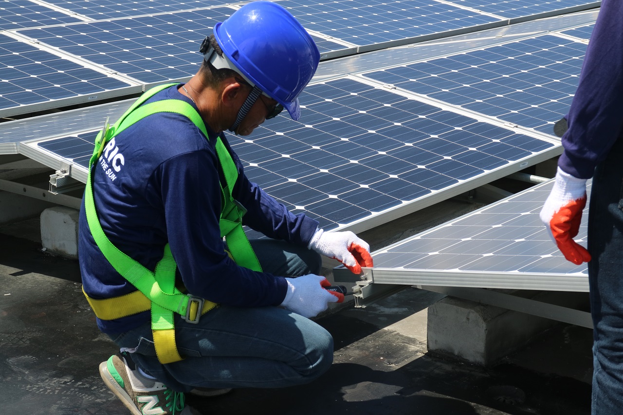 A solaric personnel installing a solar panel