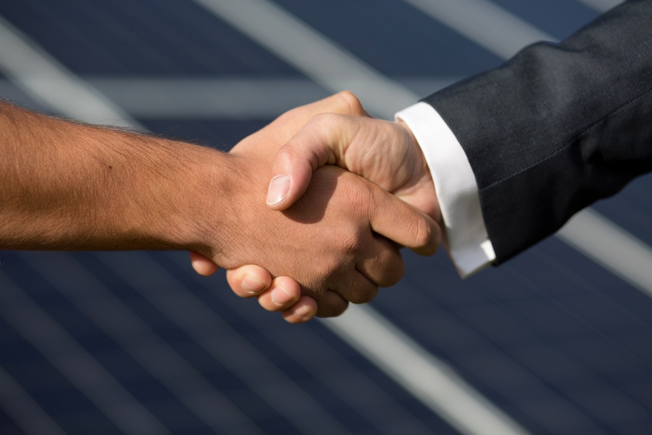 A man and his solar provider agreeing to install it into his home