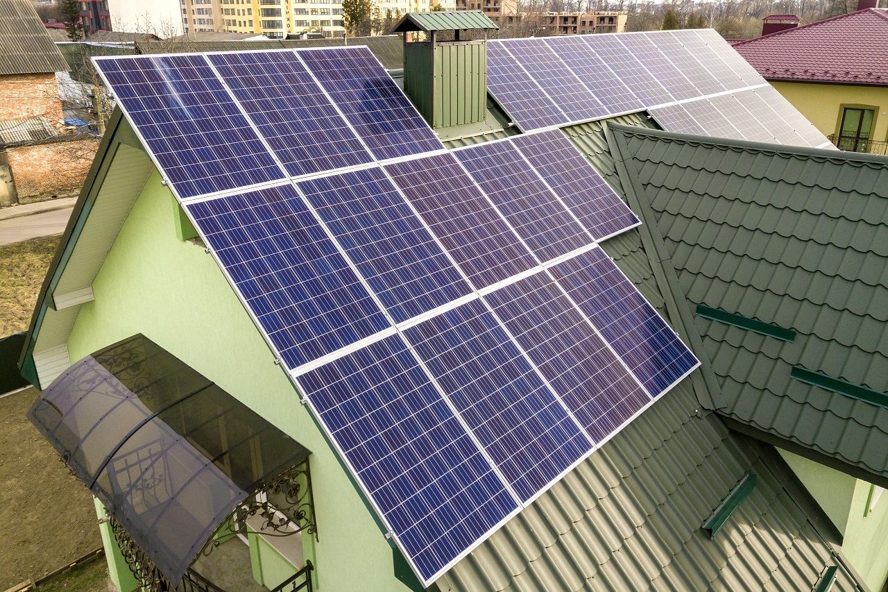 Top view of a green house with solar panels on the roof