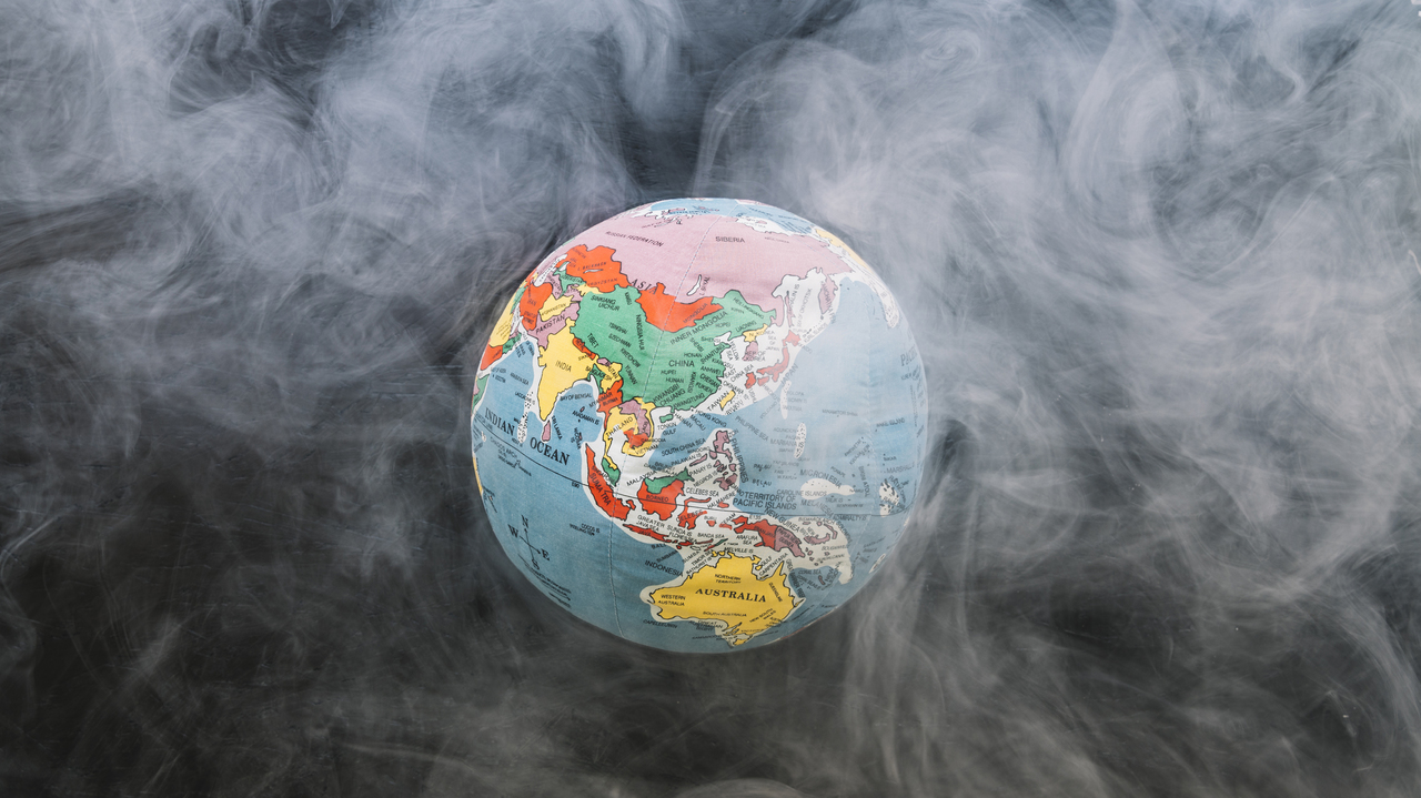 A globe of the Earth surrounded by smoke pollution