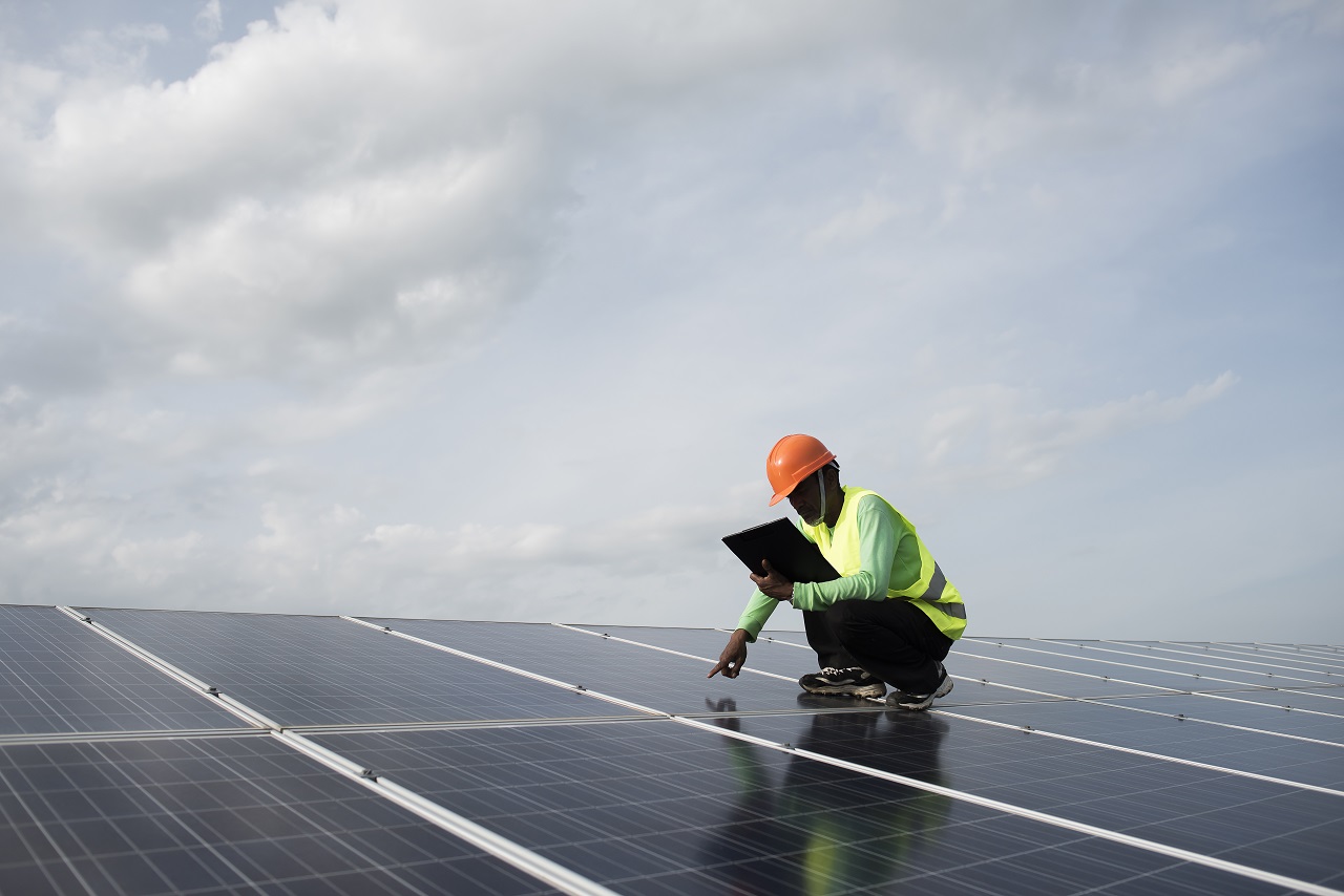 Technician looks at the solar panels