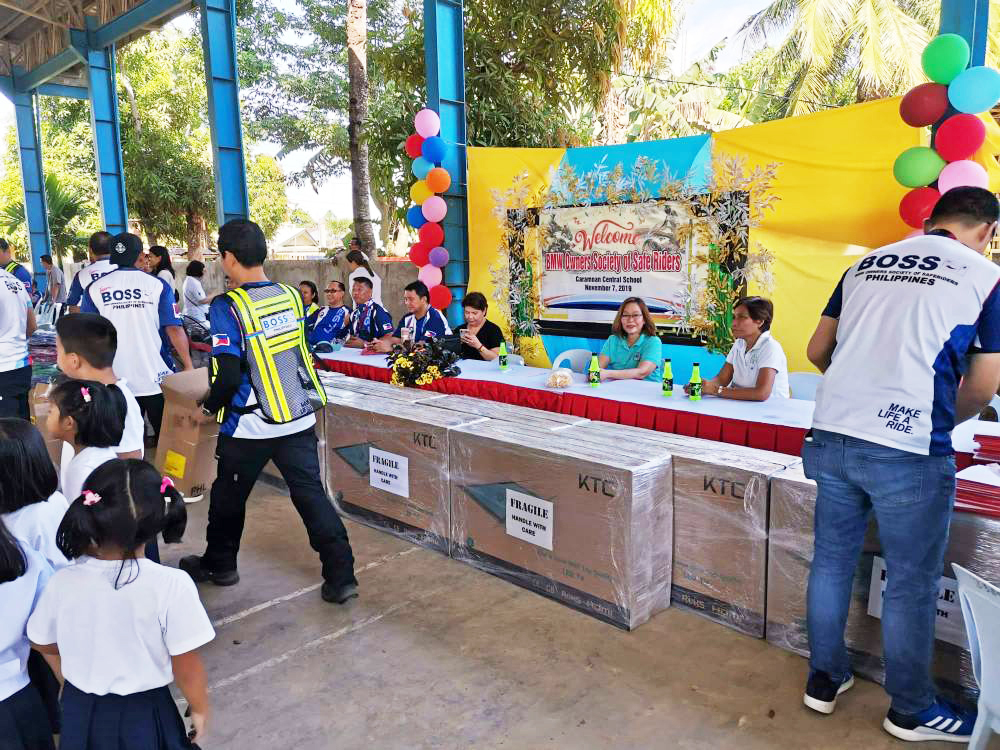 BMW Owners Society of Safe Riders (BOSS) donating televisions to a school