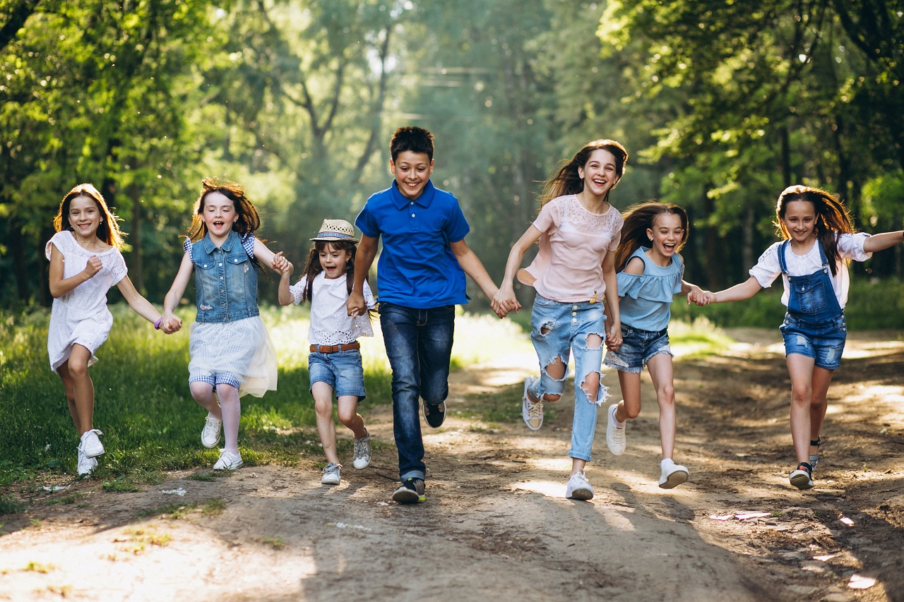 A group of children running in a park