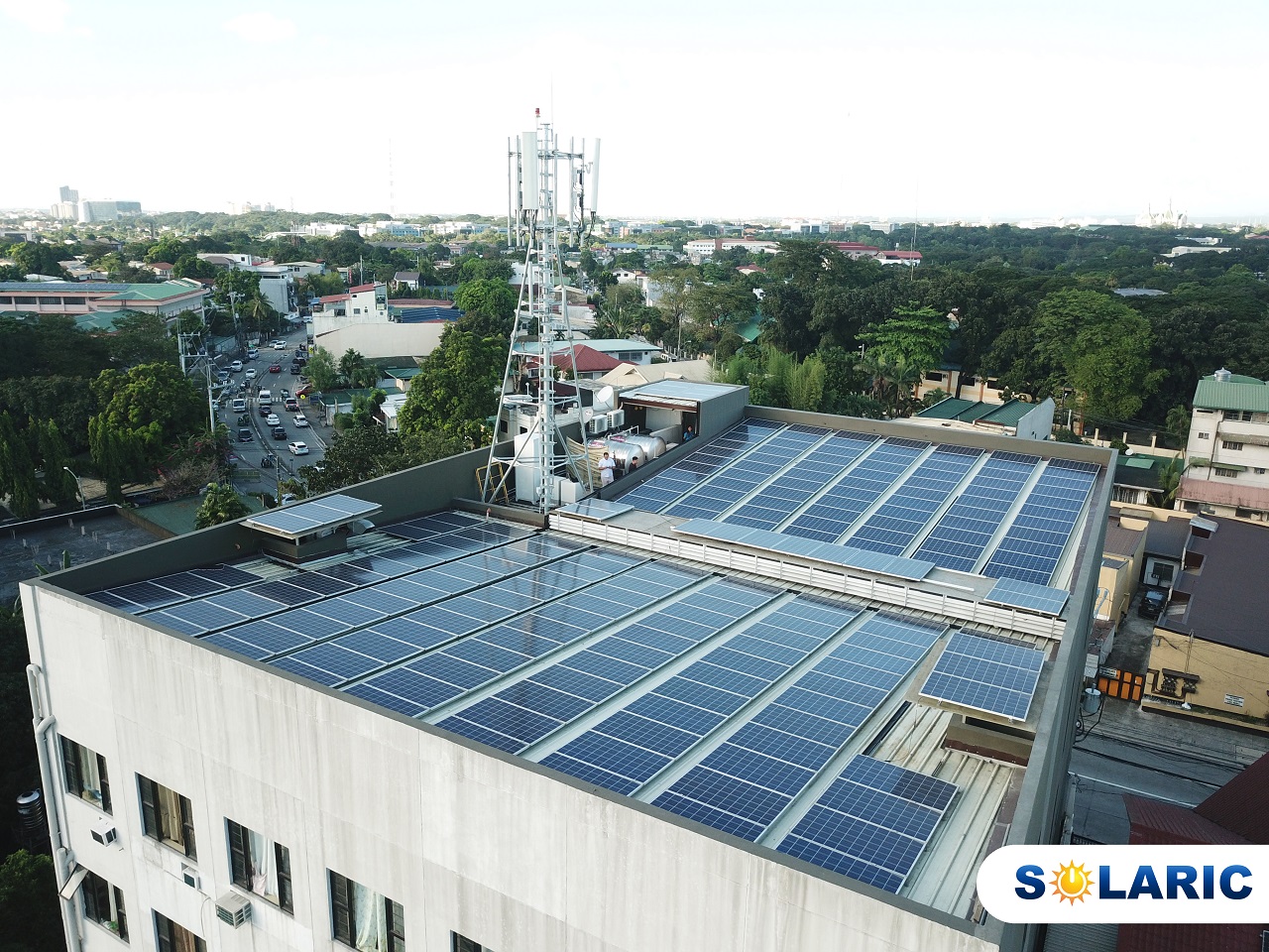 A shot of a building whose roof is completely full of solar panels